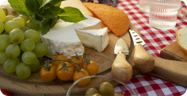 Plate with a variety of cheeses and grapes